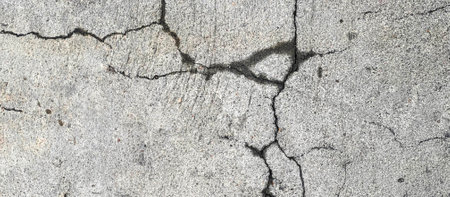 nailing on a concrete surface with a crack in the middle.