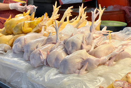 a photography of butcher shop with chicken on display in large display.の写真素材