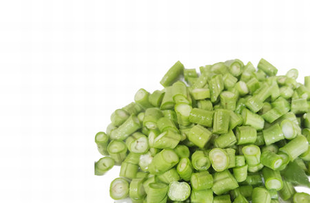 a photography of a pile of green beans on a white surface, there is a pile of green beans on a white...
