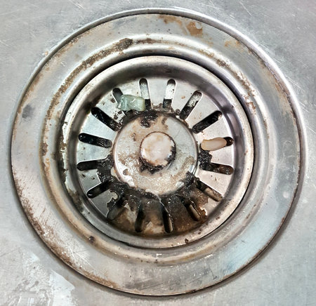 a photography of a sink drain with a dirty drain and a dirty drain, metal sink drain with a dirty metal rim.の写真素材