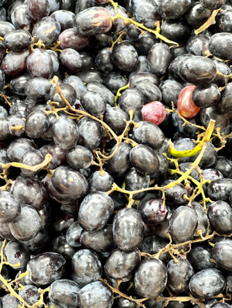 a photography of a bunch of grapes that are sitting on a table, a close up of a bunch of grapes with...