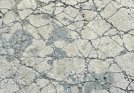 a photography of a concrete surface with cracks and cracks.の写真素材