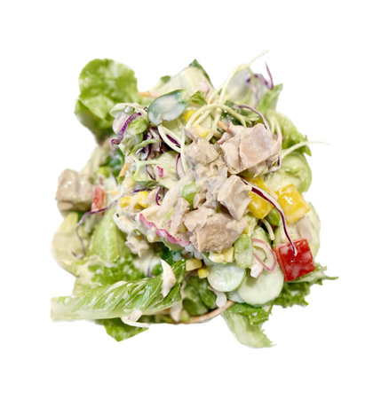 a photography of a salad with chicken, lettuce, tomatoes, and corn.の写真素材