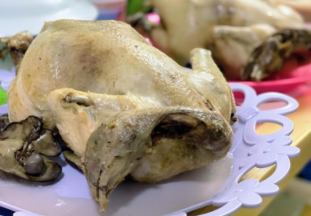 a photography of a plate of food with a chicken and mushrooms, rotisserie of a chicken on a plate with mushrooms and mushrooms.の写真素材