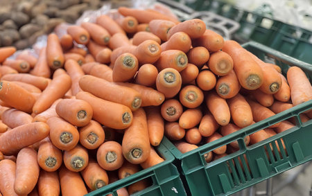 a photography of a pile of carrots in a green crate.