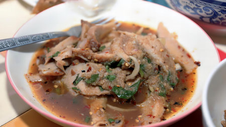 a photography of a bowl of soup with a spoon in it, hot pot of soup with meat and vegetables in a bowl.の写真素材