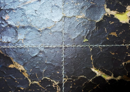 a photography of a black and yellow marble wall with a chain, cauldron of paint on a black surface...