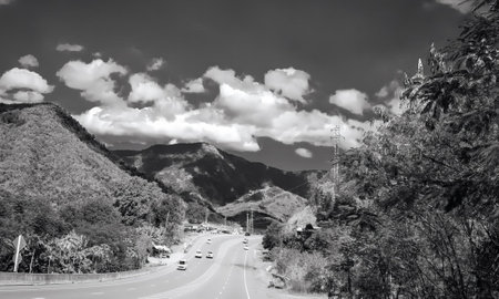 a photography of a highway with cars driving down it, alp of a highway with cars driving down it and...