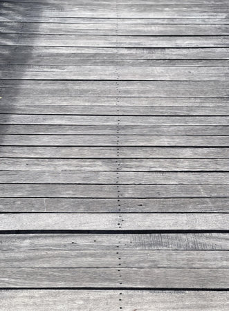 a wooden bridge with a shadow on it..
