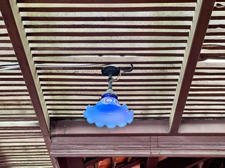 blue glass pendant hanging from the ceiling.の写真素材