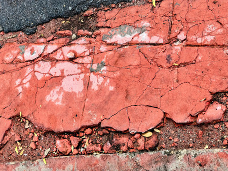 a red brick sidewalk with a crack in it.の写真素材