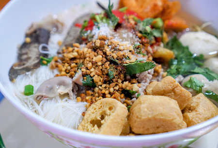 a bowl of noodles with mushrooms and rice.
