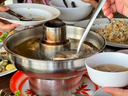 a photography of a table with a bowl of soup and plates of food.の写真素材