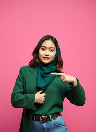 an image of a woman in a green shirt and a green scarf, woman in green shirt pointing at something with her fingerの素材