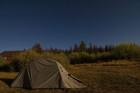 Green tent at night under the stars