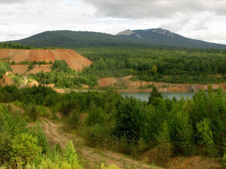 Landscape of mountains, rural road and lake