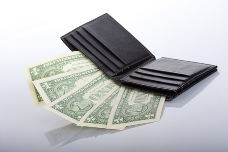 black leather purse with one dollar banknotes insideの写真素材