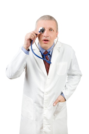 Funny senior physician holding stethoscope on his eyeの写真素材