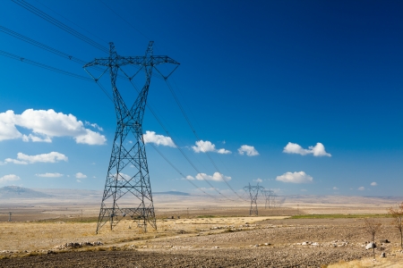 Power transmission line in the field at sunny dayの写真素材