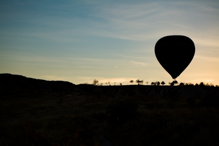 Silhouette of balloon at sunrise flying in Cappadociaの写真素材
