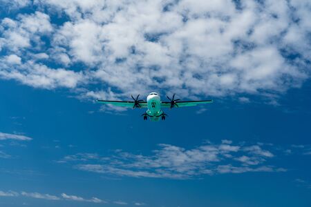 plane in sky coming in for landing