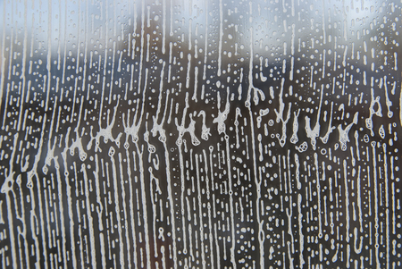 Cleaning background texture - chemical soap detergent foam on a clear glass.の写真素材