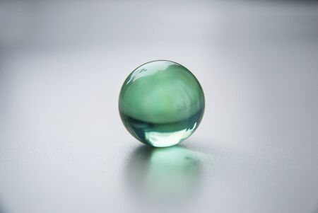 crystal glass balls in line on white grey background surface.の写真素材