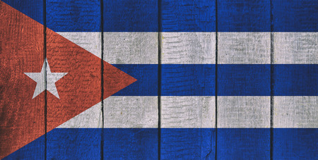 Old  wooden table texture background top view  with a National Flag of Cuba. Cuba Flags image.の写真素材