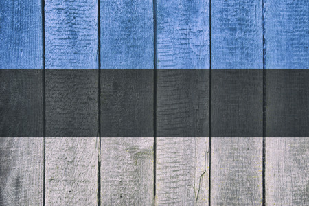 Old  wooden table texture background top view  with a National Flag of Estonia. Estonian Flags image.の写真素材