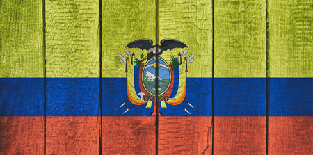 Old  wooden table texture background top view  with a National Flag of Ecuador. Ecuadorian Flags image.の写真素材