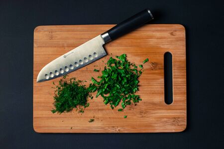 cutting board with knife and dill