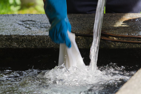 man washing clothes the old fountainの写真素材