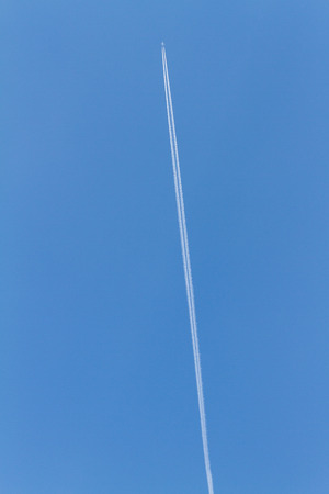 wake of aircraft in the skyの写真素材