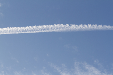 wake of the plane in the cloudsの写真素材