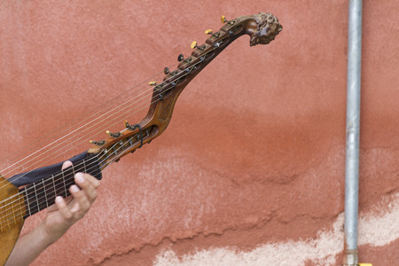 playing an old stringed instrument