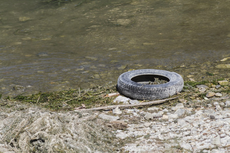 pollution tire on lakeの写真素材