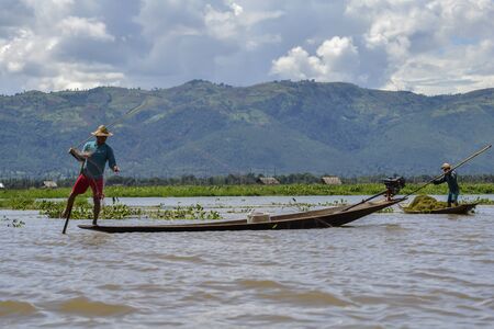 men in a boat on the riverの写真素材