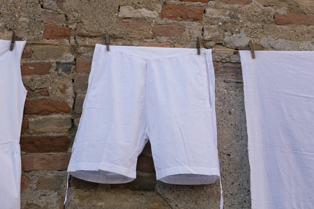 old clothes hanging out to dryの写真素材