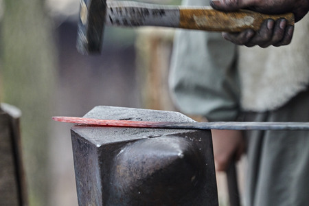 blacksmith works red hot ironの写真素材