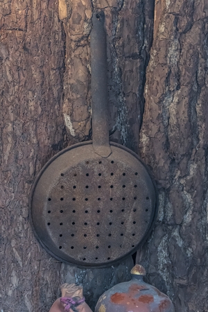 pan for roasted chestnuts on wallの写真素材