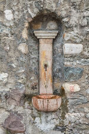 old fountain gushing in the mountainの写真素材