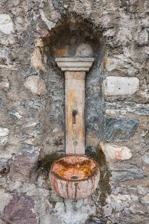 old fountain gushing in the mountainの写真素材