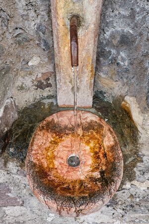 old fountain gushing in the mountainの写真素材