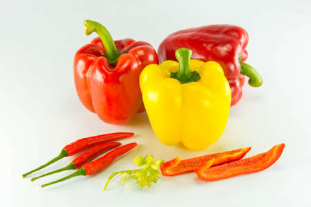 Fresh colorful sweet bell peppers  ( capsicum ) on a white background.