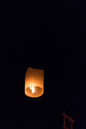 CHIANG MAI THAILAND-NOVEMBER 7 : Loy Krathong festival in Chiangmai.Tradition al monk lights floating balloon made of paper annually at Wat Phan Tao temple.On November 7,2014 in Chiangmai,Thailand.の写真素材