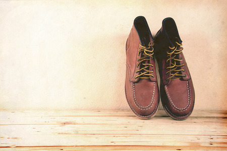 Still life with boots on wooden table background. vintage styleの写真素材