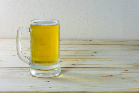 Still life with beer in a glass on wooden table backgroundの写真素材