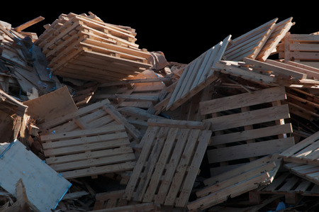 Heap of broken and discarded wood on a black background
