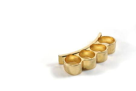 A pair of brass knuckles on a white backgroundの写真素材