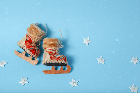 Christmas tree toy skates. Holiday celebration concept on a blue background.の写真素材